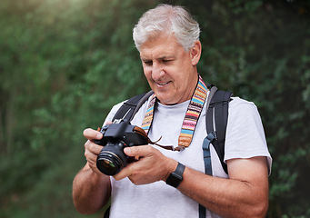 Image showing Senior man, hiking and photography with camera in forest, nature and green environment. Happy male hiker, tourist and travel photographer on trekking adventure, sightseeing journey or explore scenery