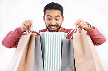 Image showing Wow, sale and happy man with shopping bag in studio, excited for discount or purchase on white background. Deal, excited and indian guy with product form shop, mall or market while posing isolated