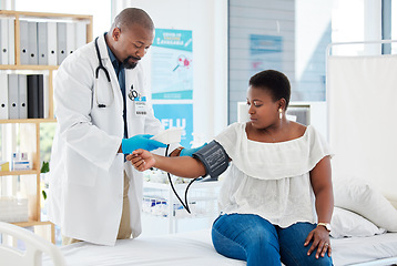 Image showing Checkup, healthcare and a doctor with a black woman for hypertension, health check and service. Help, medical and a gp consulting with a patient for blood pressure exam, cardiology or monitor