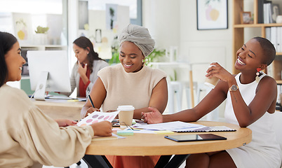 Image showing Diverse group of smiling business women planning a brainstorm meeting in office. Happy confident professional team sitting together and using paperwork, talking and cooperation on marketing strategy