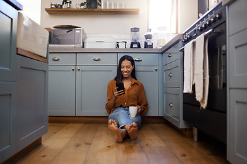 Image showing Coffee, smartphone and woman on floor, kitchen and chatting on social media, texting and message. Female, connection and lady with cellphone, tea and cappuccino with network, sms and signal in home