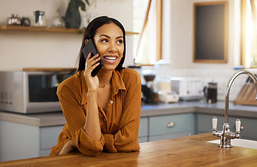 Image showing Happy woman, phone call and kitchen in a home in a conversation. House, female and smile of a person with joy resting on a counter feeling relax and happiness on a mobile talking and communication