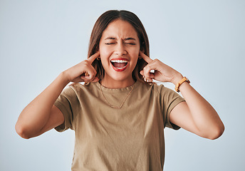 Image showing Woman, frustrated and fingers in ears, studio background and shouting with anger, annoyed and problem. Student girl, anxiety and model for mental health, angry face and depression by grey backdrop