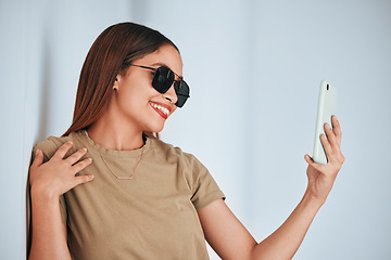 Image showing Woman, wall and sunglasses in selfie with cellphone, smile and excited with fashion for summer. Girl, student and influencer with social media app, photography and profile picture with happiness