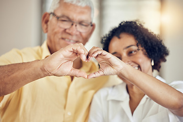 Image showing Heart, hands and senior couple in a living room with emoji for hope, love and trust in their home. Hand, shape and support symbol by old people happy with retirement, lifestyle and marriage together