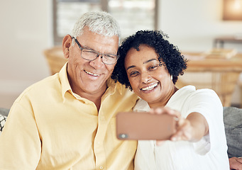 Image showing Senior couple, smile and selfie in home with love, bonding and hug for support, relax and peace on blog app. Elderly man, old woman and social media for profile picture with tech in living room