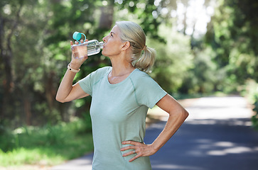 Image showing Fitness, exercise and mature woman drinking water, outdoor and training for balance, fresh air and break. Senior female, nature and lady with aqua, retirement and thirsty after practice and workout