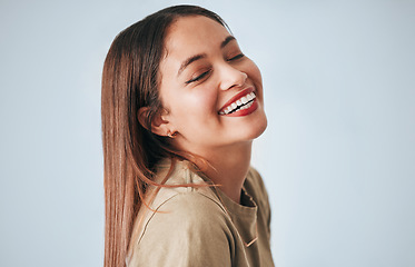 Image showing Woman, laughing and happiness of a gen z female in a studio with gray background. Isolated, happy and smile from a young person feeling carefree, youth and confidence with laughter from funny joke