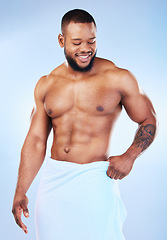 Image showing Towel, shower and fitness body of a black man with happiness from bodybuilder muscle. Cleaning, skincare and wellness after sport workout and exercise with isolated, studio and blue background