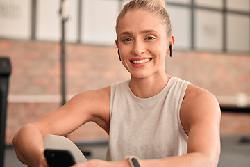 Image showing Happy woman, portrait and earphones in gym with smartphone for radio, sports podcast and training. Female, fitness and listening to music with mobile app, happiness and social media in health club