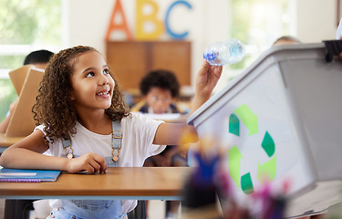 Image showing Learning, recycle bin and girl in classroom throwing trash for cleaning, climate change or eco friendly in school. Recycling plastic, smile and education with happy student or kid in kindergarten.