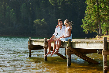 Image showing Lake, love and couple on vacation, summer and break for quality time, bonding and loving together. Romance, man and woman in nature, forest and romantic getaway for rest, relationship and happiness