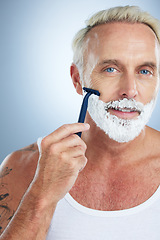 Image showing Man, portrait and razor with shaving cream for grooming beard, skincare or hair removal against studio background. Mature male face with shaver, creme or foam product for hygiene or facial treatment