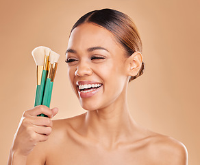 Image showing Makeup brushes, portrait or happy woman laughing with facial products or self care on studio background. Face model, smile or funny girl smiling with beauty cosmetics or natural glowing skincare