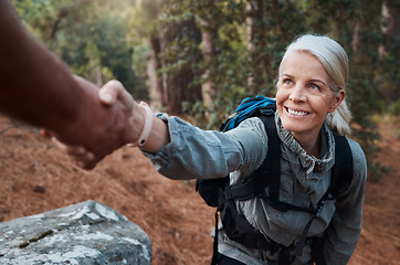 Image showing Hiking, helping hand and people in nature for climbing adventure, senior wellness and support for health. Happy woman or couple of friends hands reaching for teamwork on mountains or forest trekking