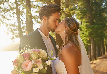 Image showing Wedding, married and couple kiss in park, forest and nature for celebration of love, care and marriage commitment. Bride, groom and kissing in garden for romance, bridal event and celebrate ceremony