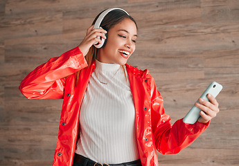 Image showing Headphones, phone and happy woman with music isolated on wood background, audio streaming and mobile app. Gen z student or biracial person with cellphone, electronics sound or online audio technology