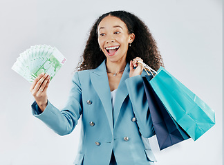 Image showing Business woman, money fan and studio with bag, shopping and excited face for discount by white background. Businesswoman, cash and smile for saving, retail sale and profit with happiness by backdrop