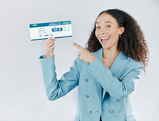 Image showing Business woman, plane ticket and portrait pointing for international travel or boarding pass against white studio background. Happy female traveler smiling for global trip, flight booking or document