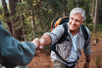 Image showing Help, holding hands and couple hiking in nature, climbing support and giving a hand. Happy, together and a person helping a senior man up a hill while on a walk in the mountains for exercise