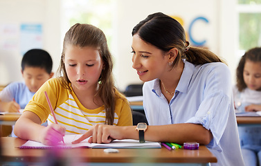 Image showing Teacher, learning and helping girl in classroom for writing, studying or assessment. Teaching, development and kid or student with happy woman for education assistance with notebook in kindergarten.