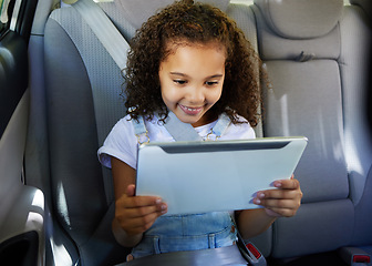 Image showing Happy, car and girl with tablet, safety and streaming cartoons with happiness, relax and apps. Young person, female child and kid with device, vehicle and travelling with smile, connection and calm