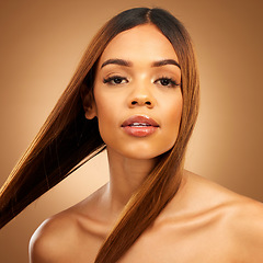 Image showing Haircare, beauty and serious portrait of woman in studio with straight hair, texture and salon shine. Latino model, healthy brunette hairstyle and natural keratin product on brown background space.