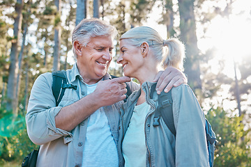Image showing Love, nature and senior couple on a hike together in a forest while on outdoor weekend trip. Happy, intimate moment and elderly man and woman in retirement trekking in woods to explore and adventure.