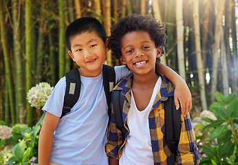 Image showing Friends, children and portrait outdoor in nature for field trip in summer with diversity and happiness. Asian and black boy kids together in a forest for adventure and summer trip with a backpack