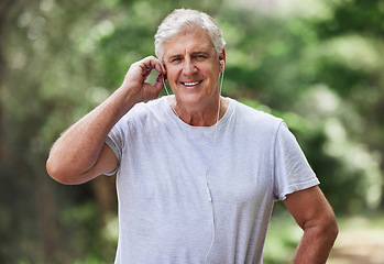 Image showing Exercise, senior man and outdoor with music earphones for run, workout and training for fitness. Elderly male happy about cardio audio for health and wellness while running in nature and retirement