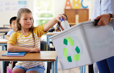 Image showing Child, classroom and recycling plastic bottle with teacher for ecology, future and climate change education. Girl, box and recycle at school, class or helping hand for environment, earth and learning