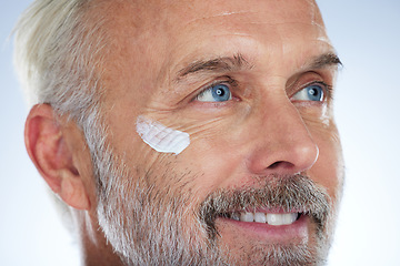 Image showing Skincare, cream and face of elderly man in studio for wellness, facial treatment and anti aging cosmetics. Beauty, dermatology and happy male with lotion, hygiene creme and moisturizer for wrinkles