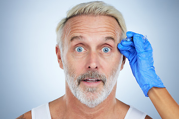 Image showing Syringe, portrait and surprise man of a senior face in a studio doing plastic surgery and cosmetic skincare. Dermatology, wrinkles and anti aging treatment of a mature model with filler injection