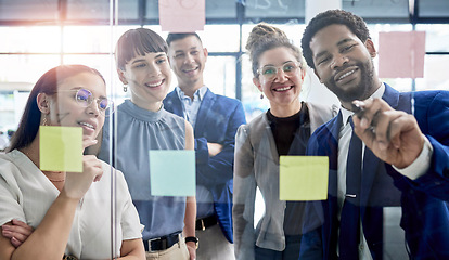 Image showing Business people, writing and meeting in schedule planning for brainstorming, teamwork or tasks on glass board at office. Happy group of employees in sticky note project plan for strategy at workplace