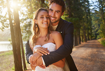 Image showing Wedding portrait, couple and hug in park, nature and support of celebration, bridal union or marriage. Happy bride, groom and hugging in garden of love, life partner or celebrate commitment in spring