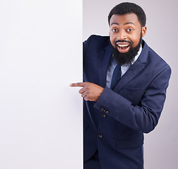 Image showing Business portrait, excited man and pointing to board in white background, studio or mockup space. Corporate worker, black male and advertising poster, marketing wow news and banner on blank mock up