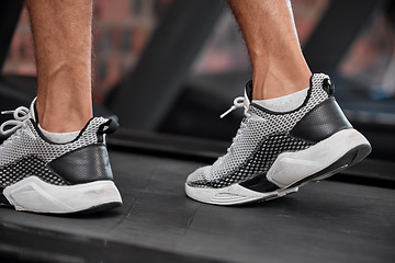 Image showing Shoes, man and running on treadmill in gym for exercise, healthy fitness and cardio workout. Closeup athlete, feet and walking machine of sports training, energy and power of action, sneakers or legs