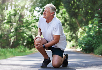 Image showing Running, injury and old man with knee pain on path in nature for outdoor fitness and workout exercise. Health, wellness and muscle strain, senior runner with hand on leg in support or relief for ache