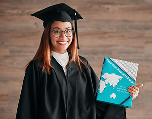 Image showing College graduation, woman and portrait with business textbook of a young student happy. Learning book, happiness and excited female ready for university education with a smile from knowledge