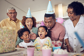 Image showing Birthday party, food and surprise with family in kitchen for celebration, bonding and affectionate. Happy, excited and grandparents with parents and child at home for generations, fun or event