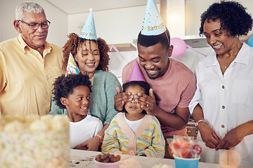 Image showing Birthday, party and surprise with family in kitchen for celebration, bonding and affectionate. Happiness, excited and care with parents and child at home for generations, fun and special event