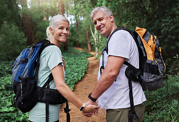 Image showing Nature, hiking and portrait of old couple holding hands on adventure in forest, woods and mountain for exercise. Fitness, retirement and happy elderly man and woman smile trekking for travel wellness