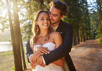 Image showing Wedding, love and couple hug in park, forest and nature for celebration of union, care and marriage commitment. Portrait of happy bride, groom and hugging in garden for romance, partner and happiness