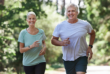 Image showing Senior couple, exercise and running outdoor for happy workout and training for fitness. Elderly man and woman laugh for cardio, health and wellness on run in nature forest for healthy retirement