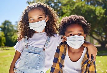 Image showing Kids hug, park and mask for covid in portrait with support, care or outdoor in summer sunshine. Children, friends and embrace with girl, safety and solidarity at school, playground and backyard lawn