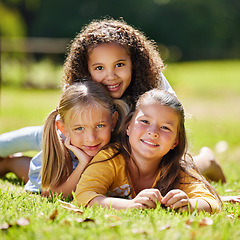 Image showing .Summer, girls portrait or happy kids on grass in park together for fun, bonding or playing in nature. Smile, diversity or young best friends smiling or embrace on school holidays in outdoor field.