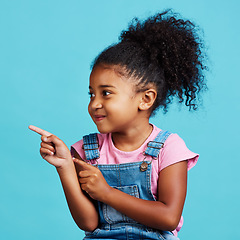 Image showing Studio, youth girl and kid point at commercial promotion, advertising copy space or marketing mockup. Child growth mock up, brand product placement and young female face isolated on blue background