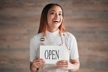 Image showing Cafe, portrait and woman holding an open sign in studio on a blurred background. Coffee shop, small business startup and management with a young female entrepreneur indoor to display advertising