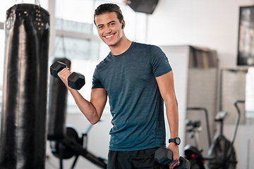 Image showing Portrait, dumbbells and man in gym smile with earphones for streaming music while exercising. Sports workout, fitness and happy bodybuilder or athlete lifting weights for exercise, health and muscle.