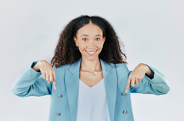 Image showing Business woman, pointing down and studio portrait for mockup, promotion and space by white background. Happy entrepreneur, smile and hand sign for suggestion, mock up and happiness for company promo